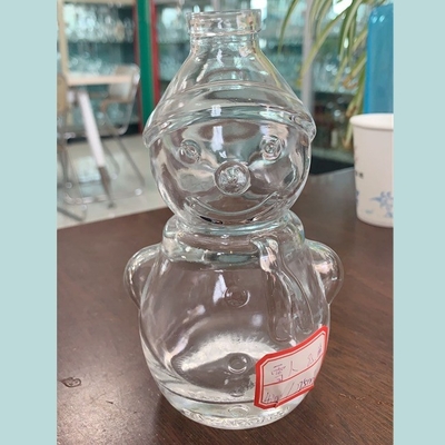 Botella de whisky transparente de cristal de sílex en forma de muñeco de nieve con manejo de superficie decal