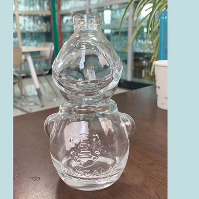Botella de whisky transparente de cristal de sílex en forma de muñeco de nieve con manejo de superficie decal